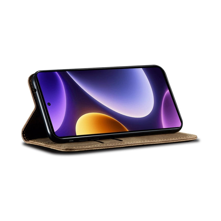Denim-textured brown flip phone case folded open as a stand with phone screen visible