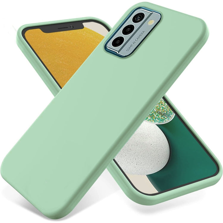 Mint green liquid silicone phone case with raised edges and triple camera cutout