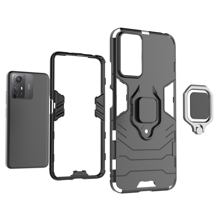 Magnetic ring holder phone case, rugged shell with openings, dark gray/black color.