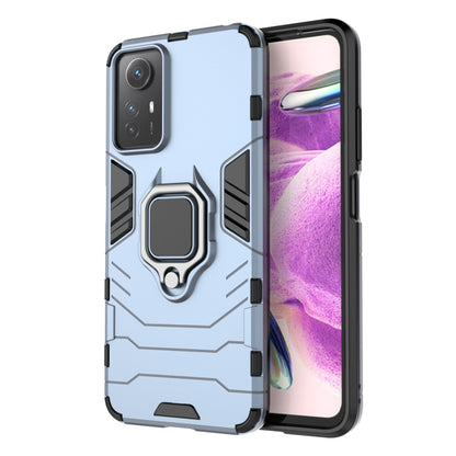Magnetic ring phone case with rugged armor pattern, light blue color, protective cutouts.