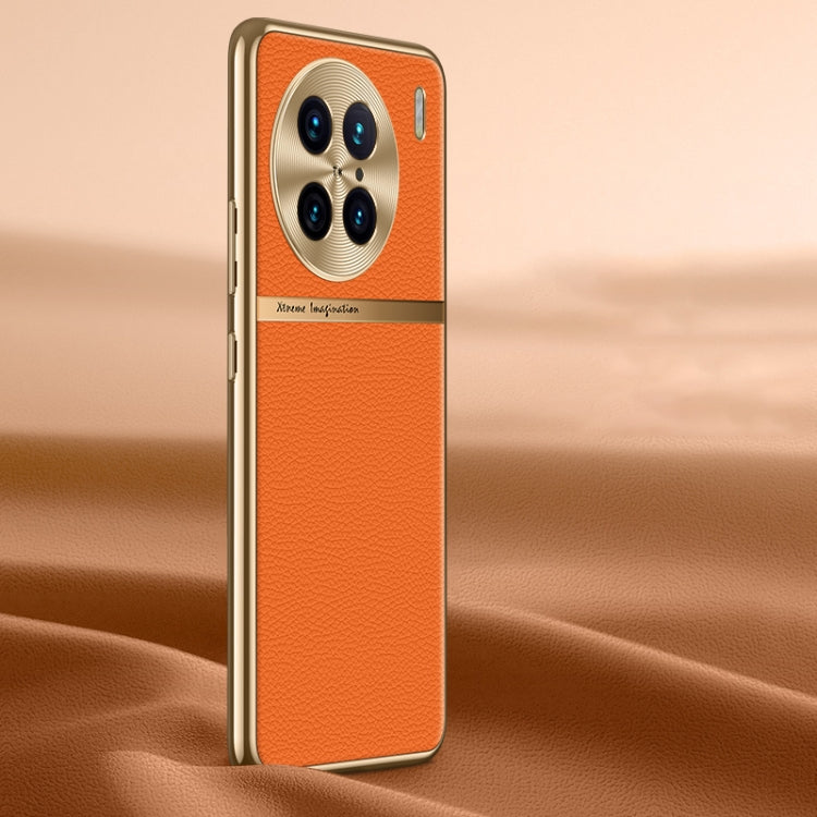 Orange litchi-texture genuine leather phone case with raised camera cutout.