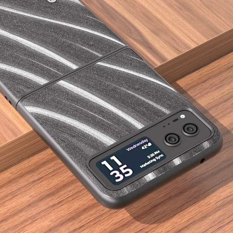 Protective phone case detail: dark gray textured surface with wavy stripe pattern