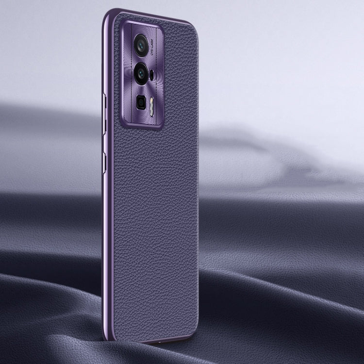 Purple litchi-texture genuine leather phone case with camera cutout, side angle.