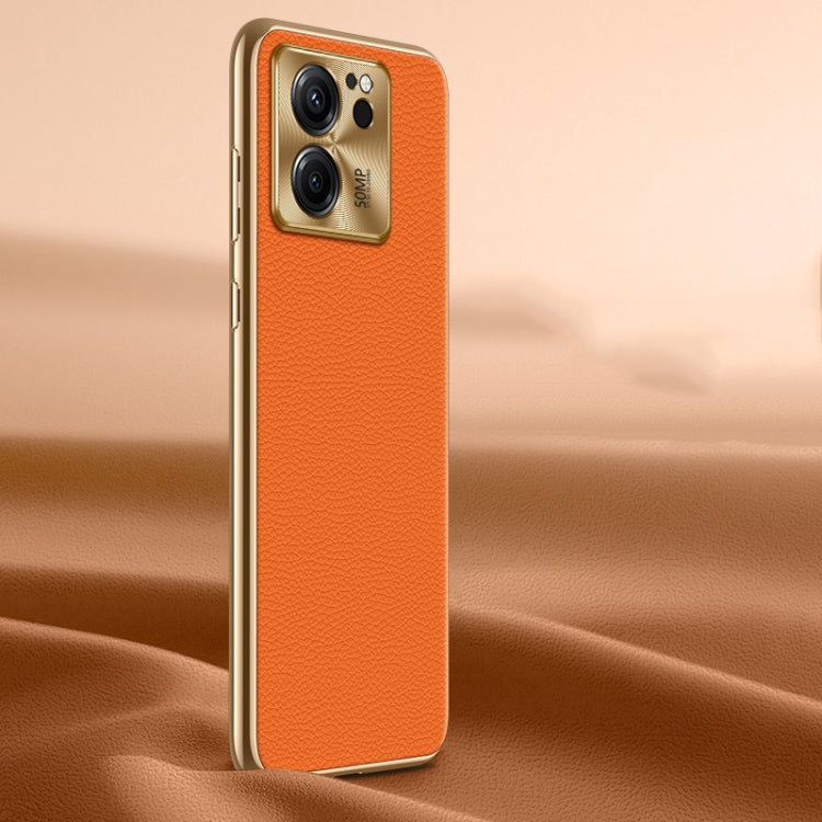 Orange litchi-texture genuine leather phone case, back view with camera cutout.