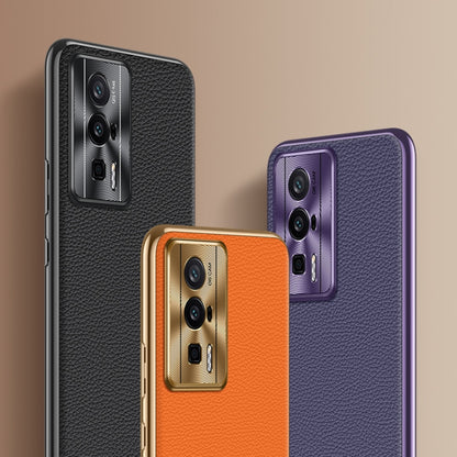 Set of litchi-texture genuine leather phone cases in black, orange, and purple