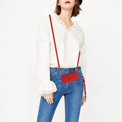 Red strap phone wallet case worn crossbody with embossed flip cover