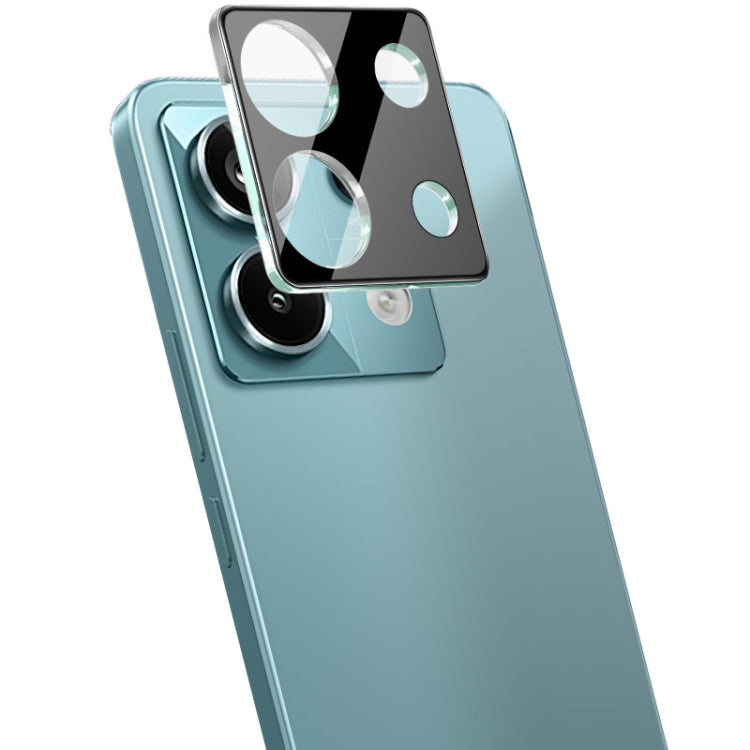Black integrated glass camera lens film covering a phone camera module