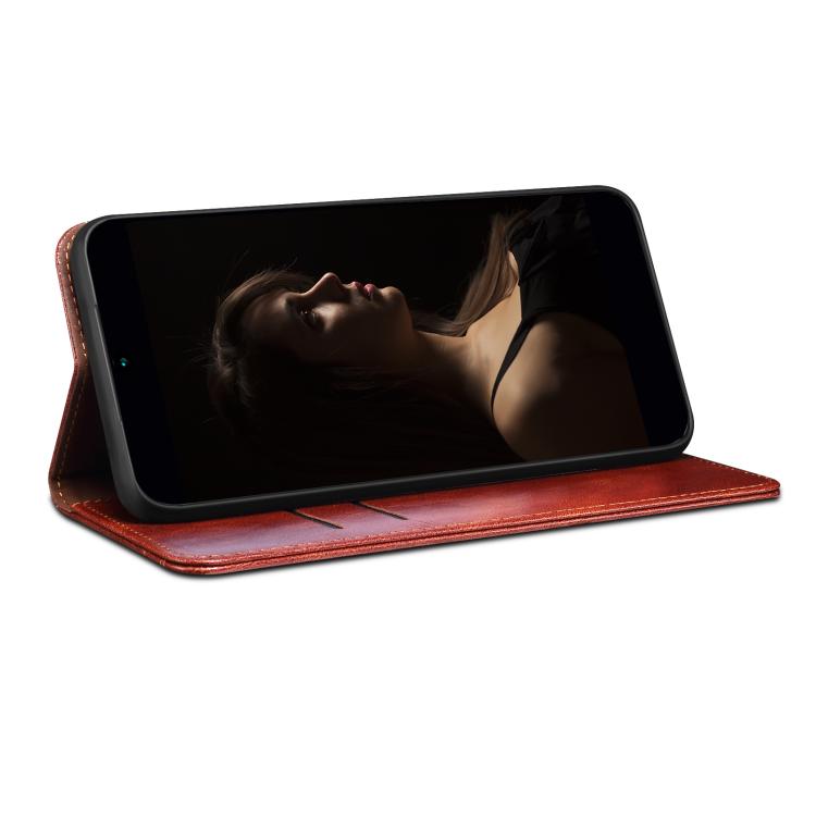 Brown leather folio phone case with flip cover supporting phone in landscape view