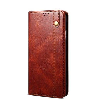 Brown slim leather phone case with pebbled crazy horse texture, seam stitching, and button