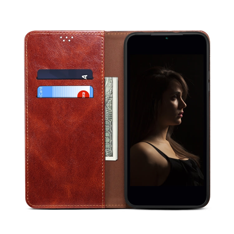 Brown leather phone case with card slot window and snap strap closure for a smartphone