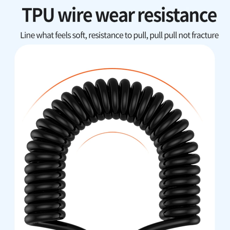 Black coiled spring cable for charging, flexible TPU wire close-up