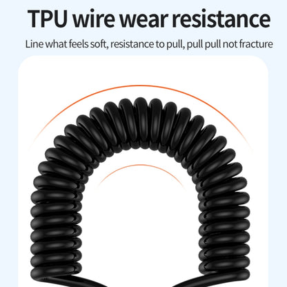 Black coiled spring cable for charging, flexible TPU wire close-up