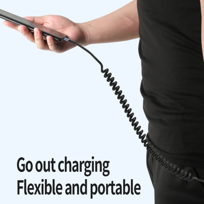 Flexible coiled charging cable with black spiral cord, compact and portable