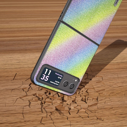 Rainbow glitter diamond-edge phone case with kickstand raised on a wood surface