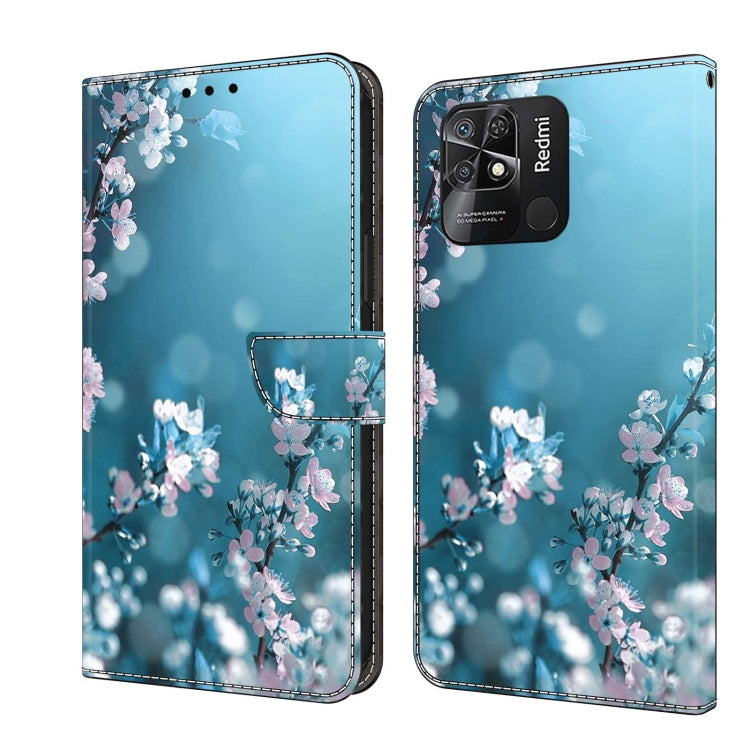 Leather-look flip phone case with blue background and pink cherry blossom print