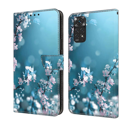 Light blue leather folio phone case with pink blossoms and butterfly accents