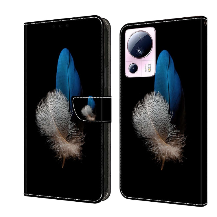 Wallet-style leather phone case with blue feather and silver feather detail on black