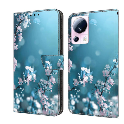 Wallet-style leather phone case with light blue background and pink blossom floral pattern