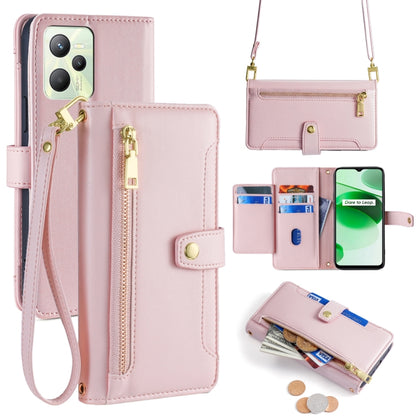 Pink leather cross-body phone wallet with zip, card slots, and removable wrist strap