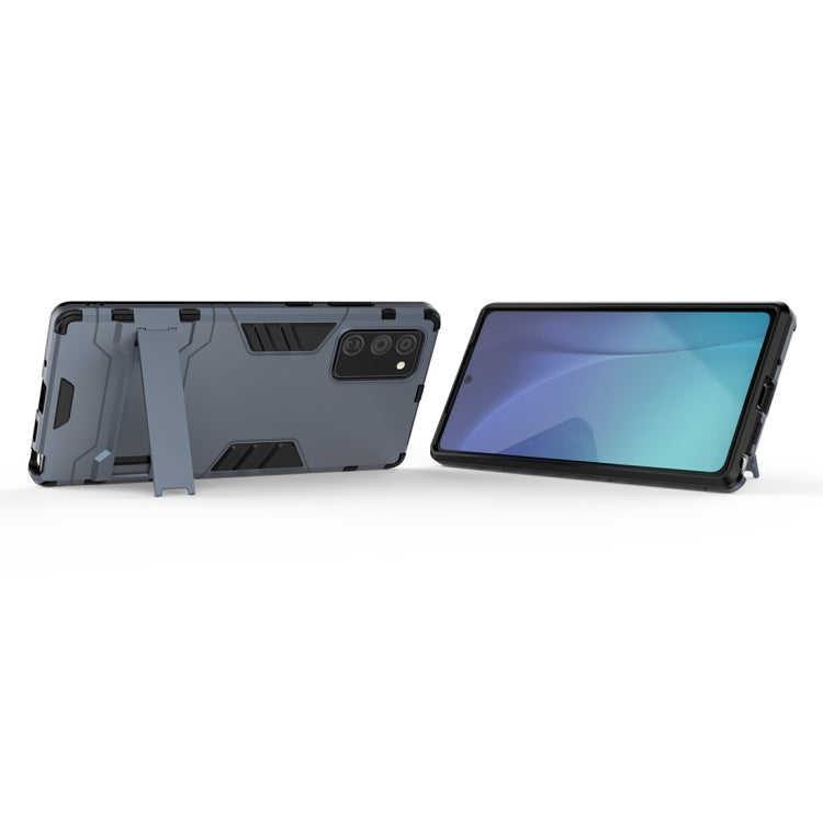 Light blue-gray rugged phone case with black trim, shown side and front angle