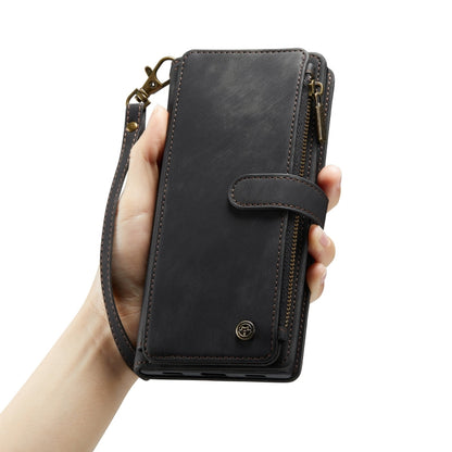 Black leather phone wallet case held in hand with wrist strap and zipper