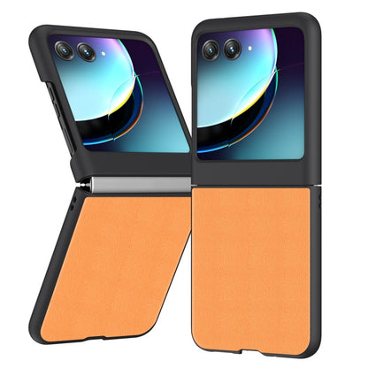 Orange leather flip phone case with camera cutouts, front cover closed