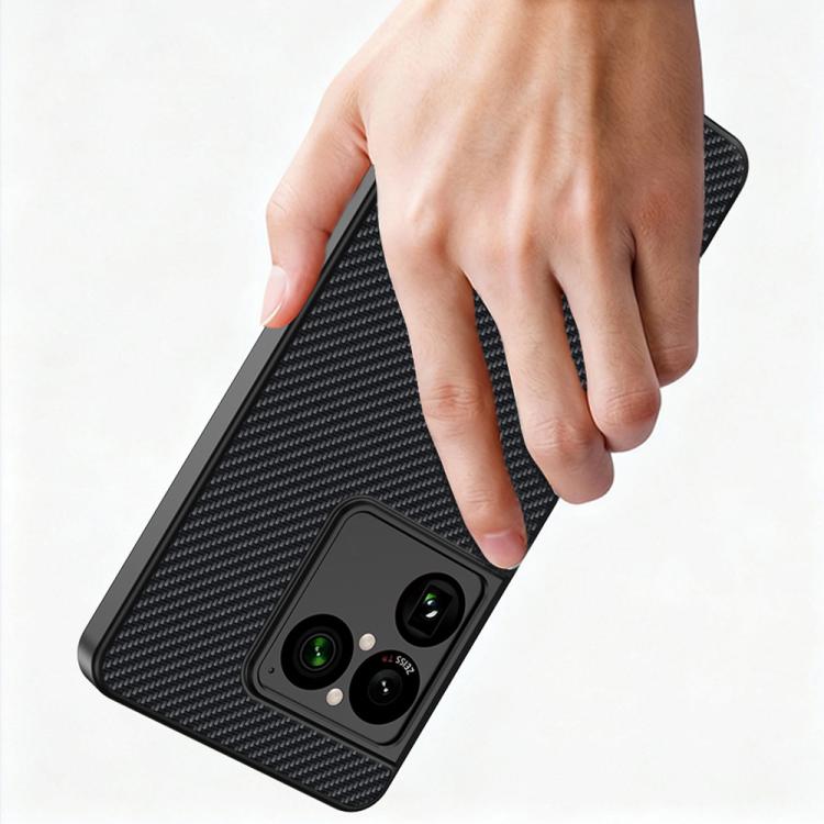 Black carbon-fiber texture phone case with camera cutouts, gripped by hand