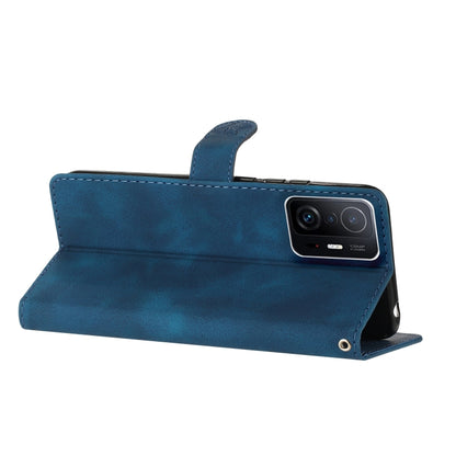 Blue leather wallet-style phone case with side strap and camera opening