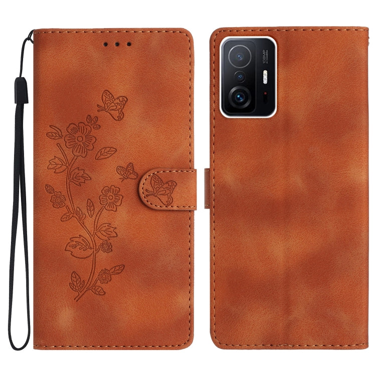 Brown leather phone case with embossed floral butterfly pattern, folio style and wrist strap