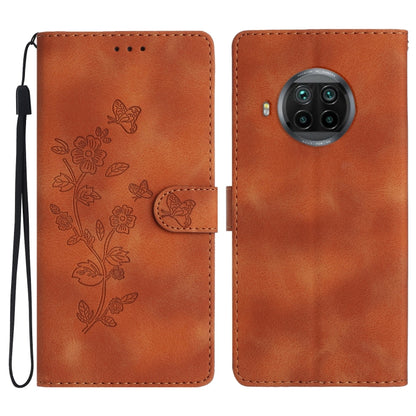 Brown leather folio phone case with embossed flowers and butterflies, wrist strap and camera cutout