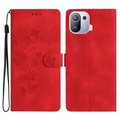 Red leather folio phone case with embossed flower and butterfly pattern, wrist strap