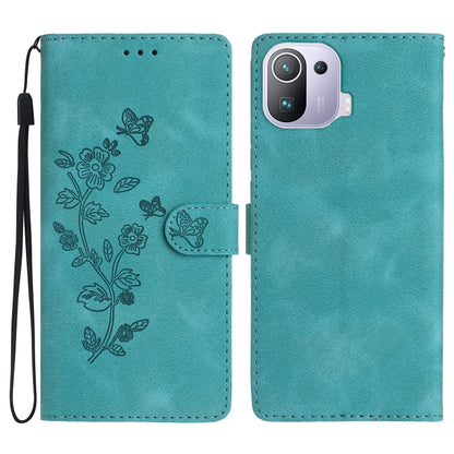 Sky blue leather folio phone case with embossed flower and butterfly pattern, wrist strap