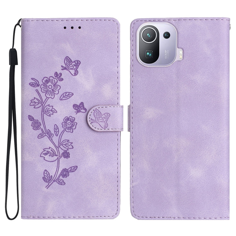 Purple leather folio phone case with embossed flower and butterfly pattern, wrist strap