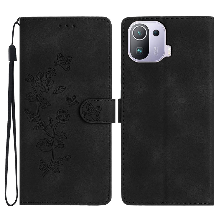 Black leather folio phone case with embossed flower and butterfly pattern, wrist strap