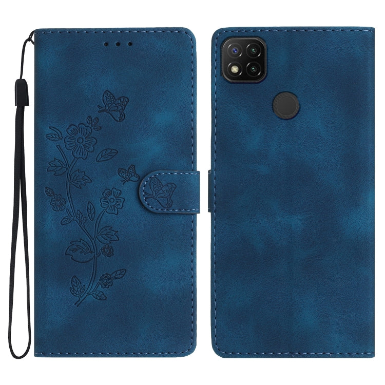 Blue embossed leather phone case with butterfly-flower pattern, wrist strap, flip cover.