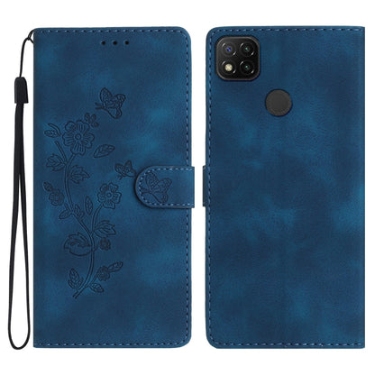 Blue embossed leather phone case with butterfly-flower pattern, wrist strap, flip cover.