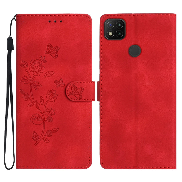 Red embossed leather phone case with butterfly-flower pattern, wrist strap, flip cover.