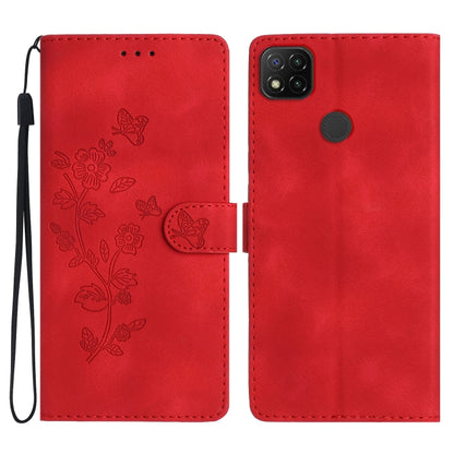 Red embossed leather phone case with butterfly-flower pattern, wrist strap, flip cover.