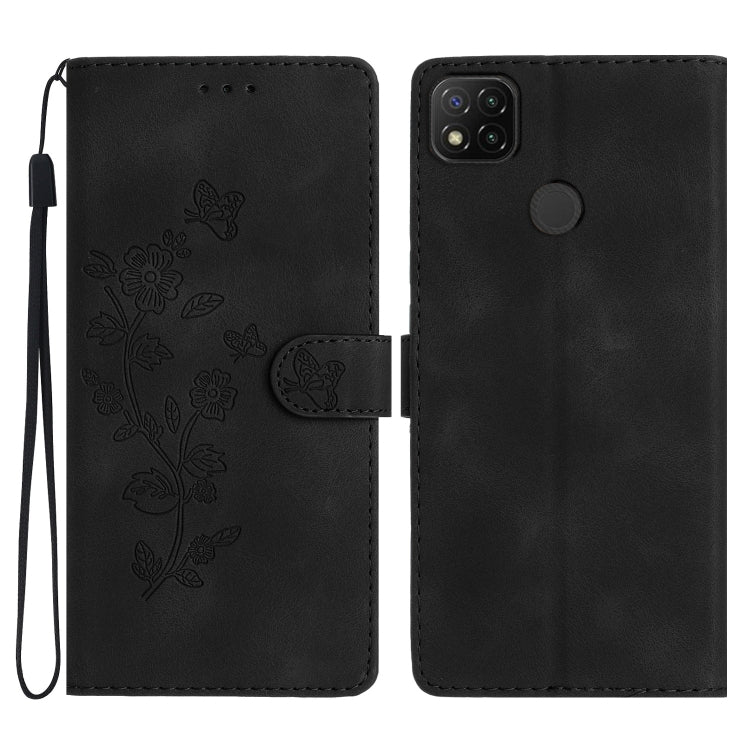 Black embossed leather phone case with butterfly-flower pattern, wrist strap, flip cover.