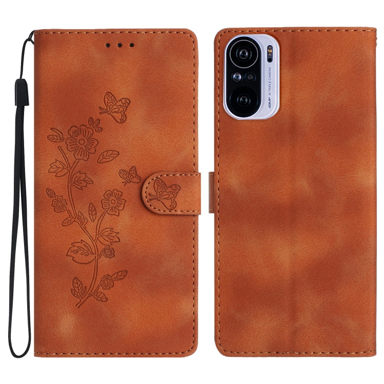 Rust-brown leather phone case with embossed flower and butterfly pattern, magnetic flap