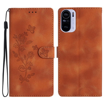 Rust-brown leather phone case with embossed flower and butterfly pattern, magnetic flap