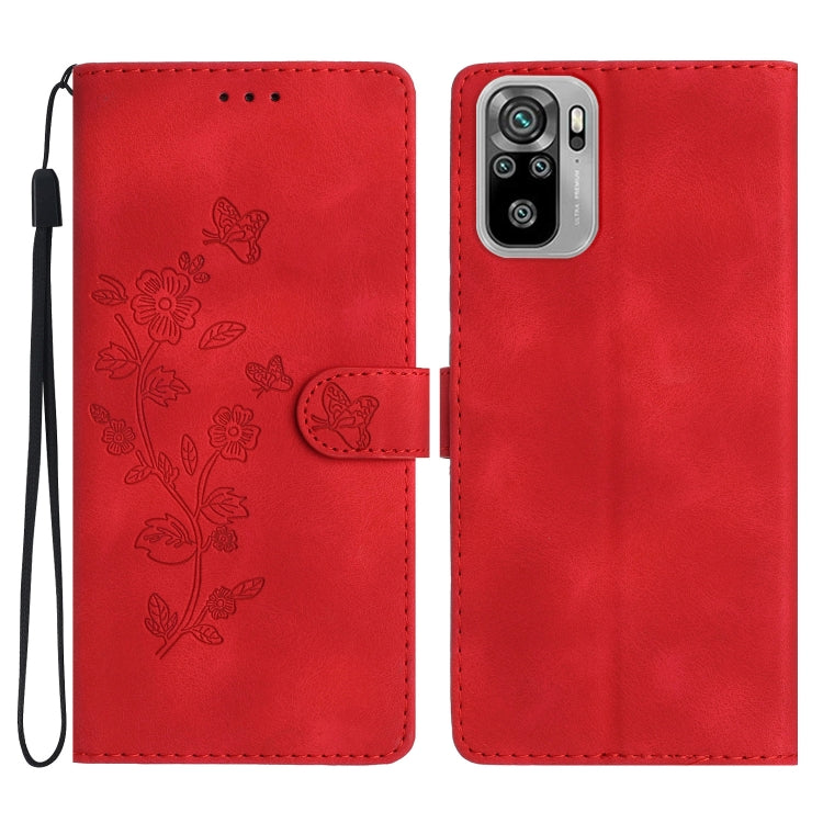 Red leather wallet phone case with embossed butterfly-and-flower pattern and wrist strap