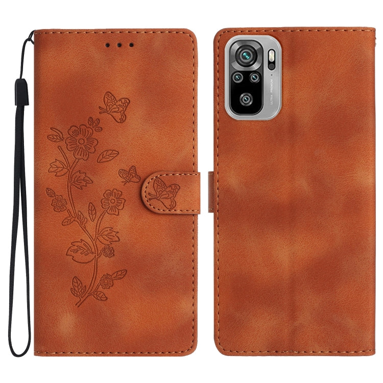 Brown leather wallet phone case with embossed butterfly-and-flower pattern and wrist strap