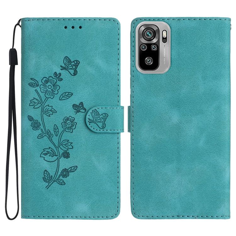 Teal leather wallet phone case with embossed butterfly-and-flower pattern and wrist strap