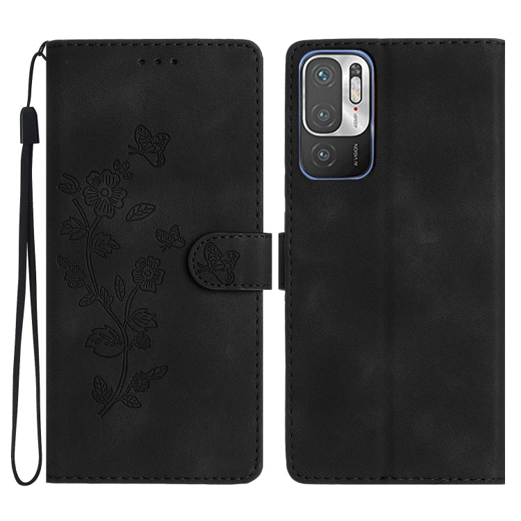Black leather wallet phone case with embossed butterfly-and-flower pattern and wrist strap