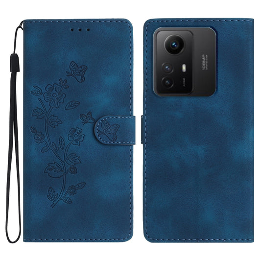 Blue leather phone wallet case with embossed floral butterfly pattern and wrist strap