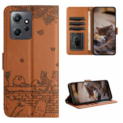 Brown cat-embossed leather-style phone case with lanyard and card slots for cards.