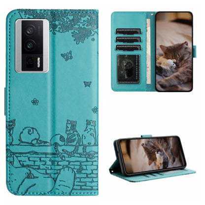 Teal cat-embossed leather-style folio phone case with lanyard and card slots.