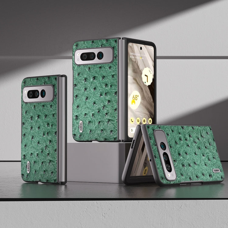 Green ostrich-textured leather fold phone case on display with hinge and camera cutout