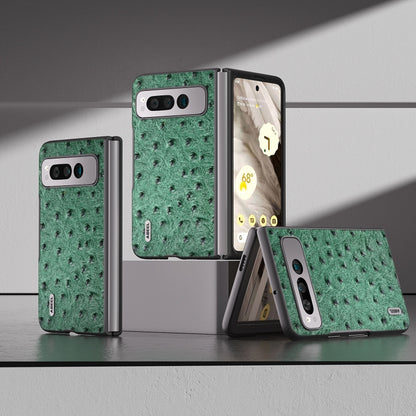 Green ostrich-textured leather fold phone case on display with hinge and camera cutout